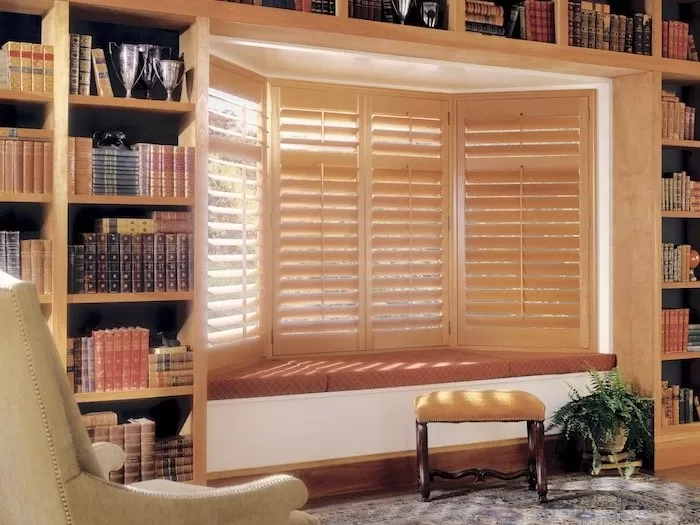 Heritance® Hardwood Shutters on a bay window.