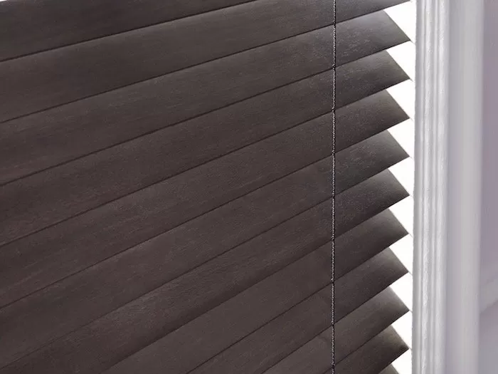 The de-Light feature on these Parkland® Wood Blinds eliminates light spots