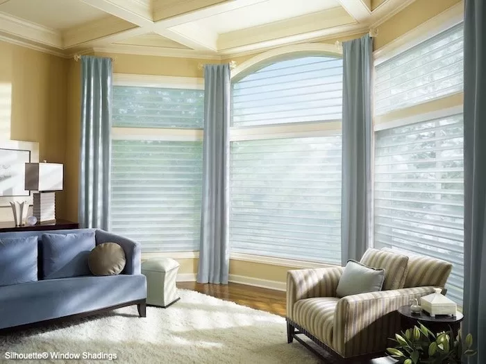 Specialty windows expand the elegance and interest in a room. custom drapery